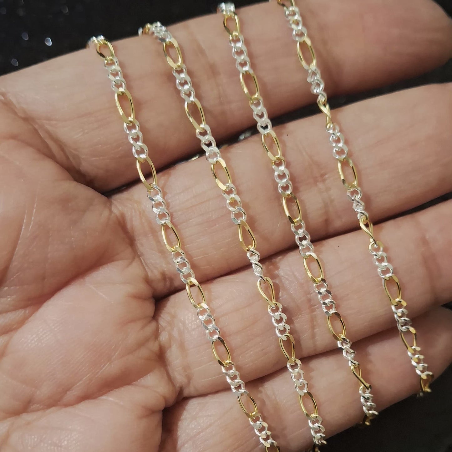 Close-up of mixed metal Figaro chain showing alternating sterling silver and 18k gold vermeil links