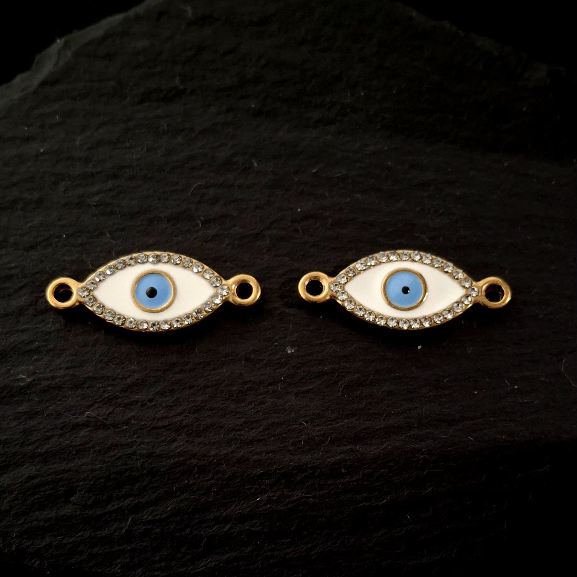 Evil eye bracelet connectors close up on a black hard surface SSAV 
