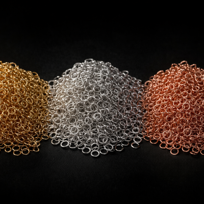 Group shot of mixed 14k gold filled and sterling silver jump rings, rose gold filled jump rings emphasizing variety and no minimum order quantity.