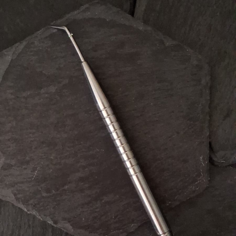 Metallic tool on a dark textured surface
