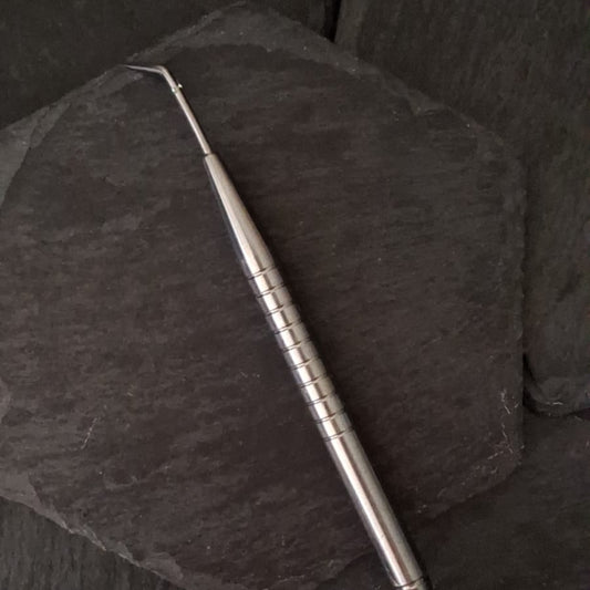 Metallic tool on a dark textured surface